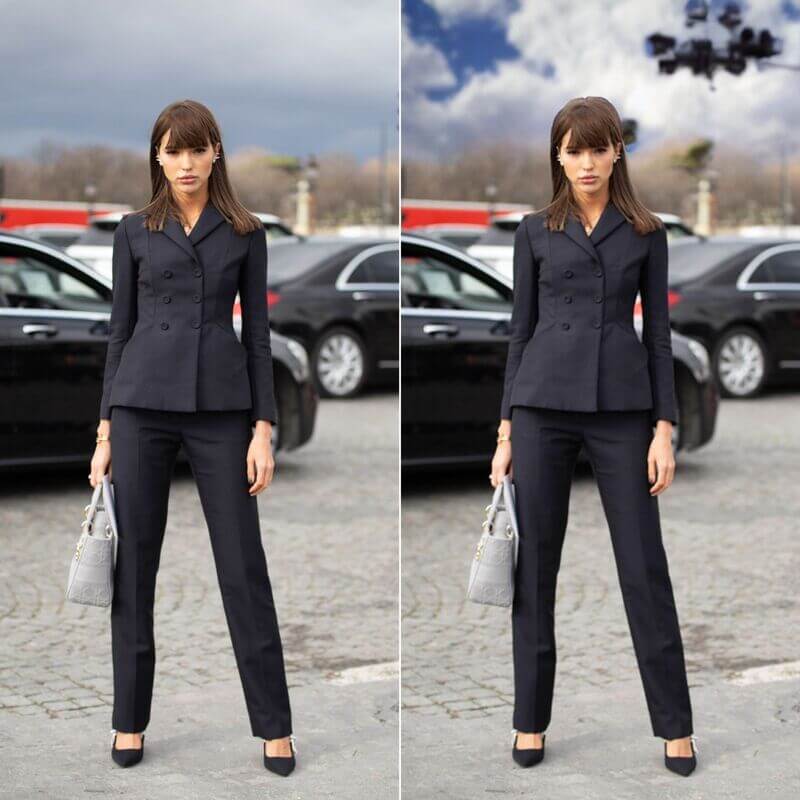 Woman wearing a black pants suit standing in a parking lot