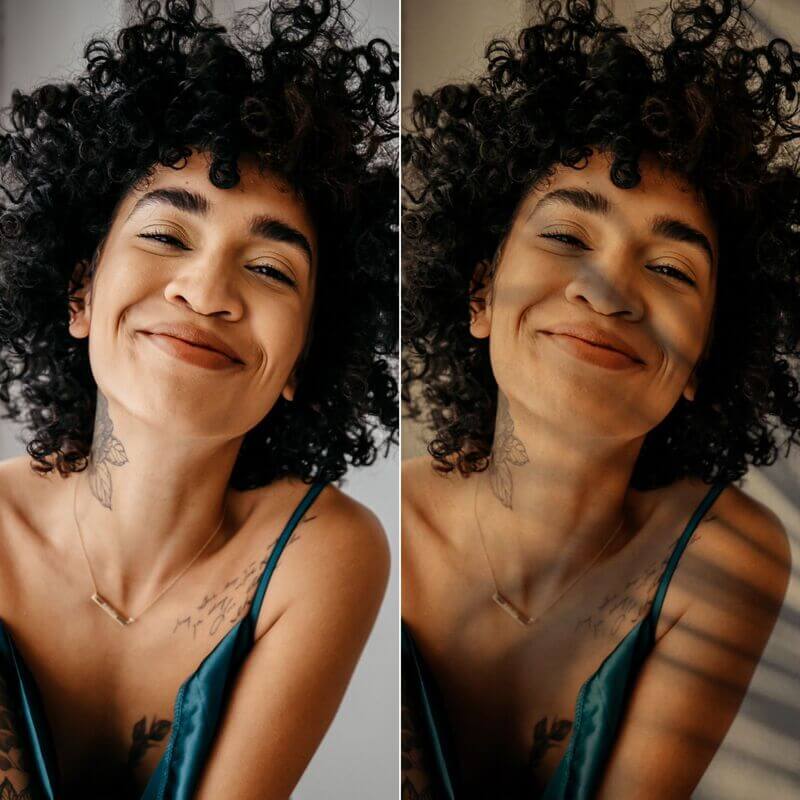 Woman with curly hair wearing a green top smiling into the camera